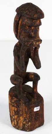 Une ancienne petite statuette assise les mains 