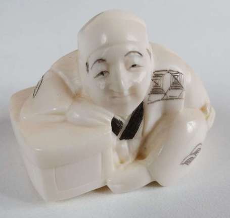 Netsuke en ivoire, il figure un personnage accoudé