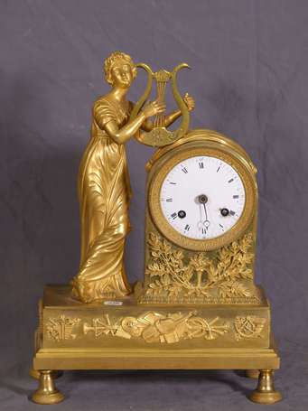 Pendule en bronze doré figurant une jeune femme 